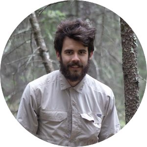 Ian Grossenbacher-Mcglamery, caucasian man with short brown hair and beard standing in a forest 